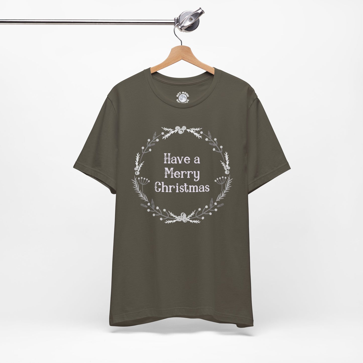 Green t-shirt with 'Have a Merry Christmas' text on a hanger against a white background