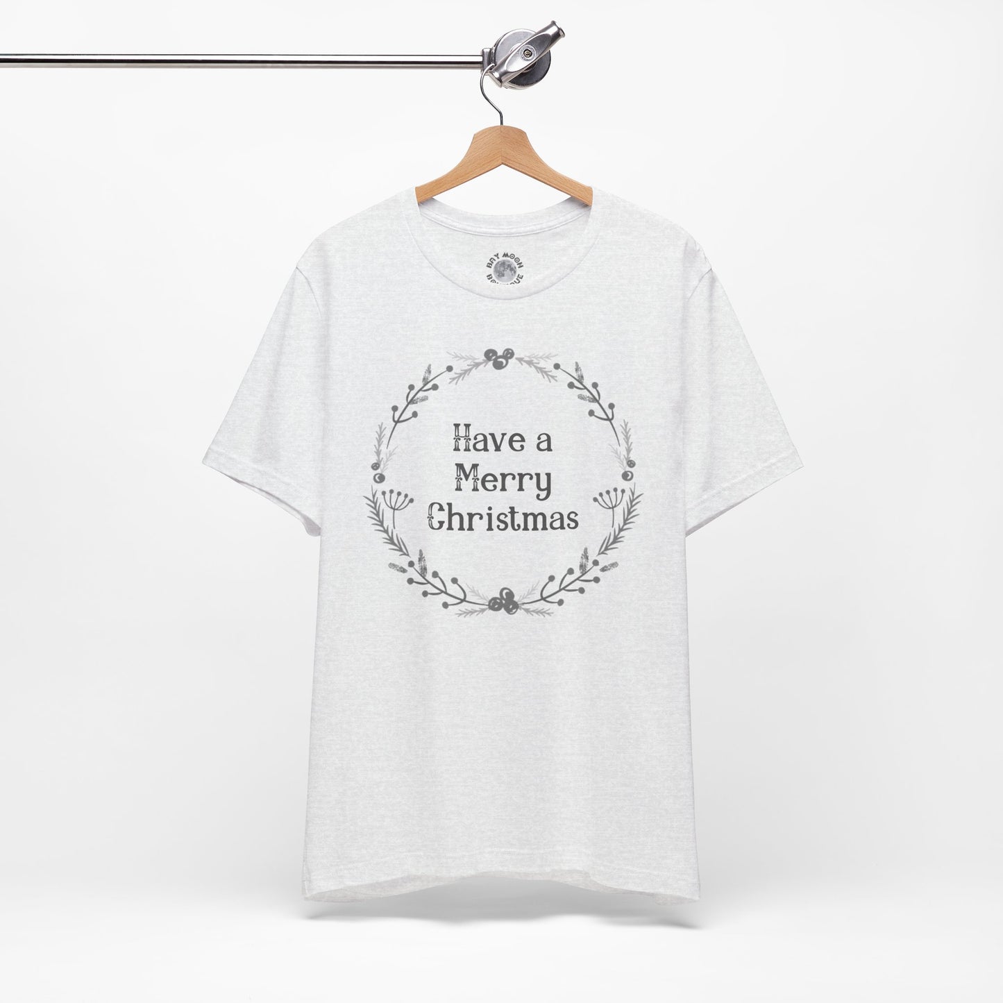 White t-shirt with 'Have a Merry Christmas' text on a hanger against a white background