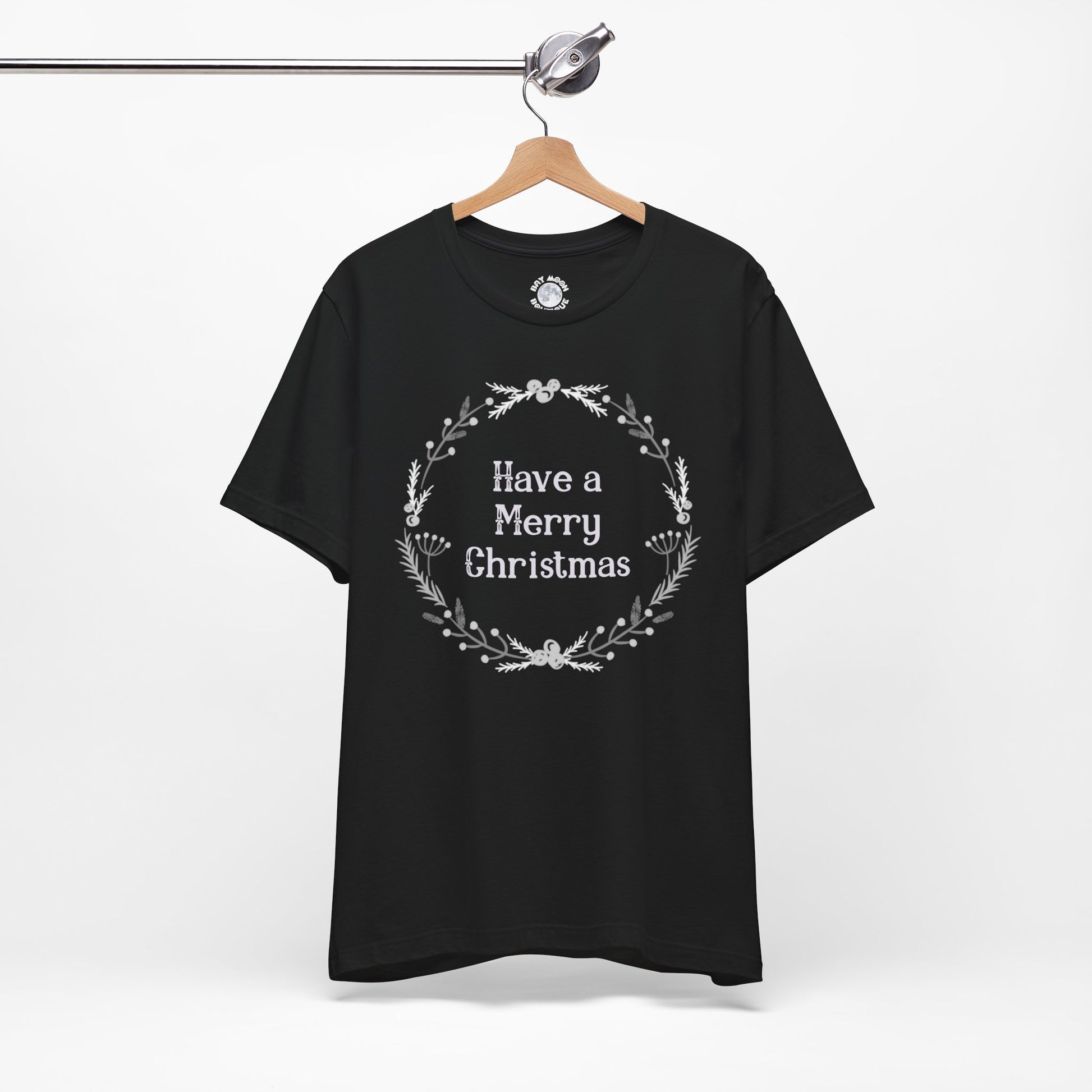 Black t-shirt with 'Have a Merry Christmas' text on a hanger against a white background