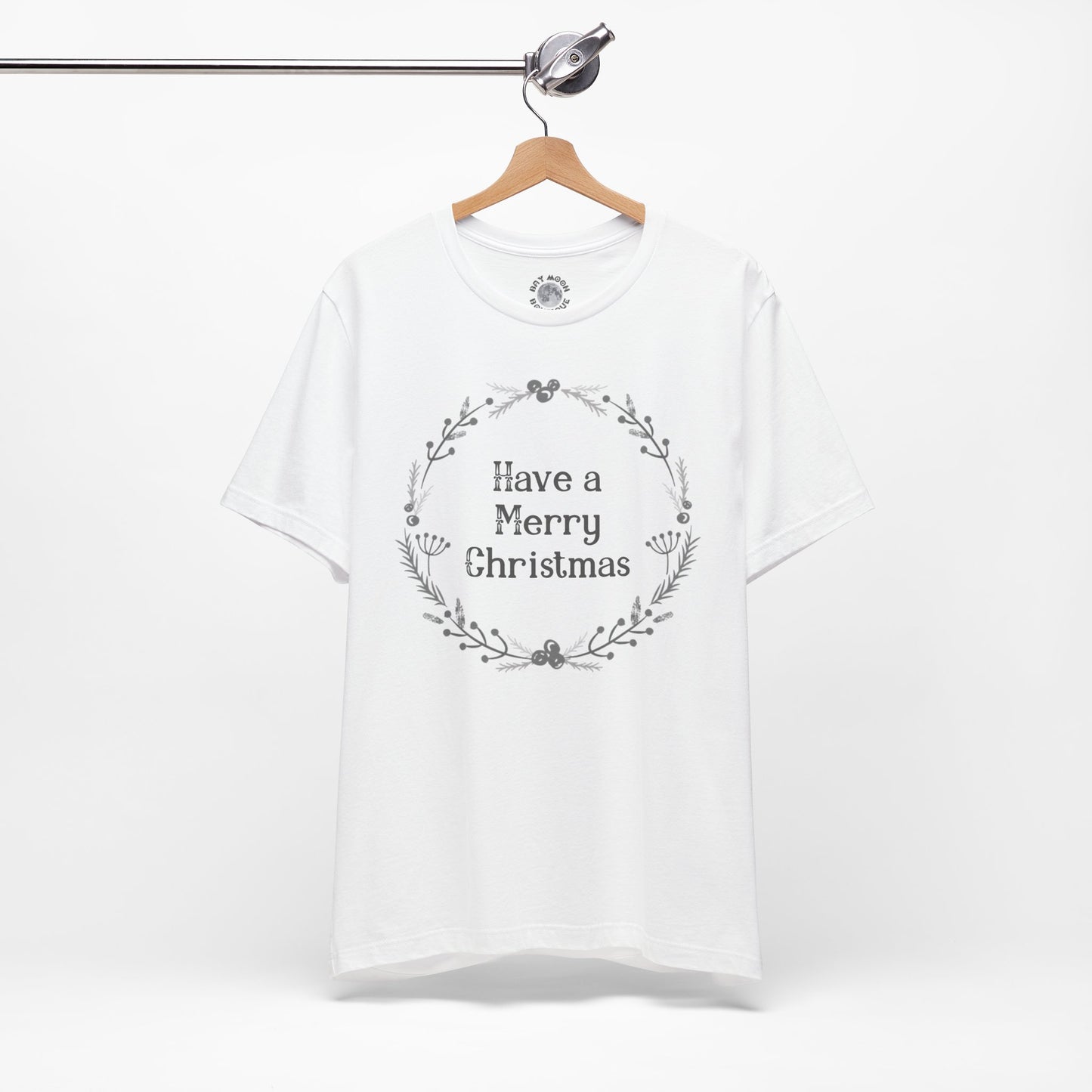 White t-shirt with 'Have a Merry Christmas' text on a hanger against a white background